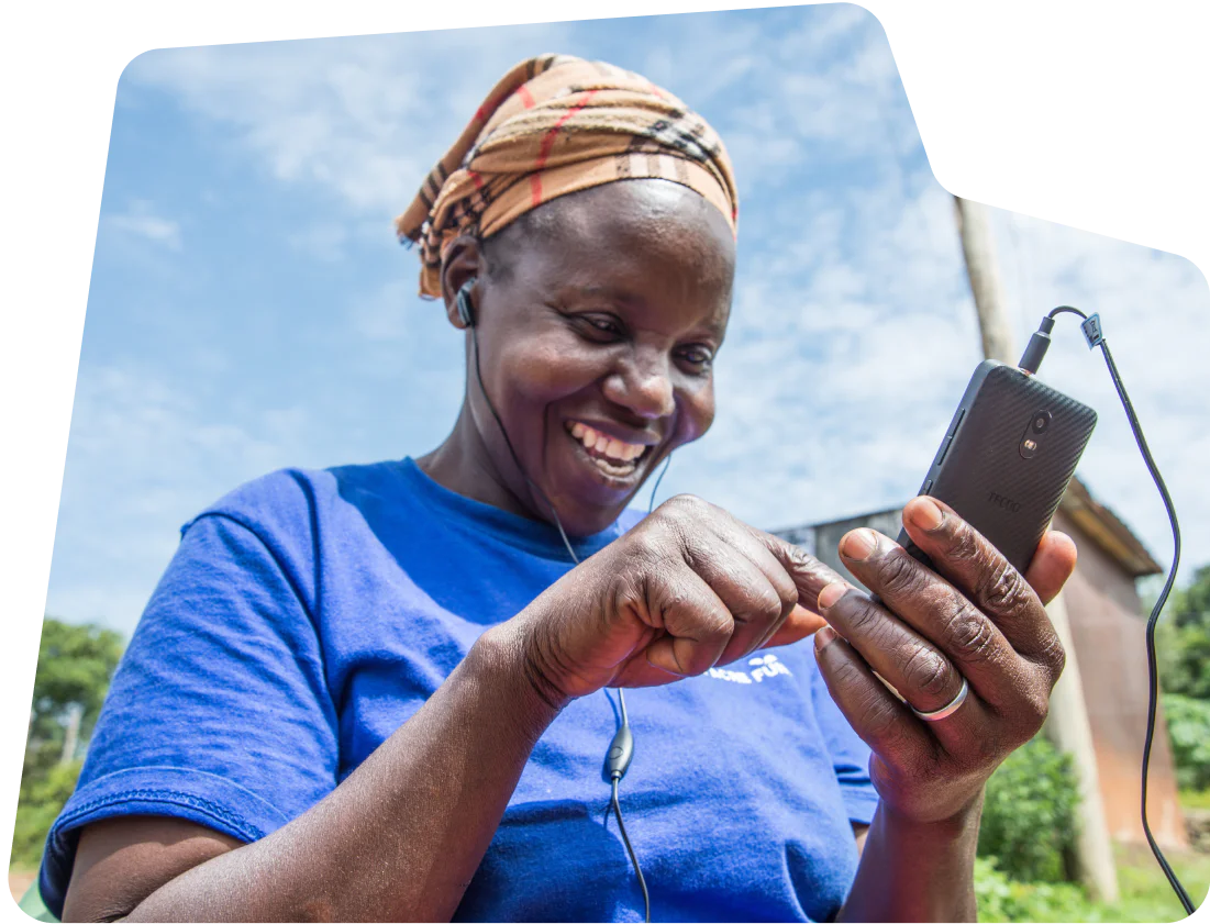 Woman joyfully using smartphone outdoors. Woman joyfully using a smartphone outdoors.