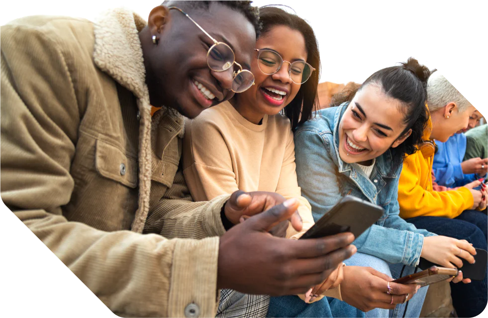 Friends smiling while looking at a phone